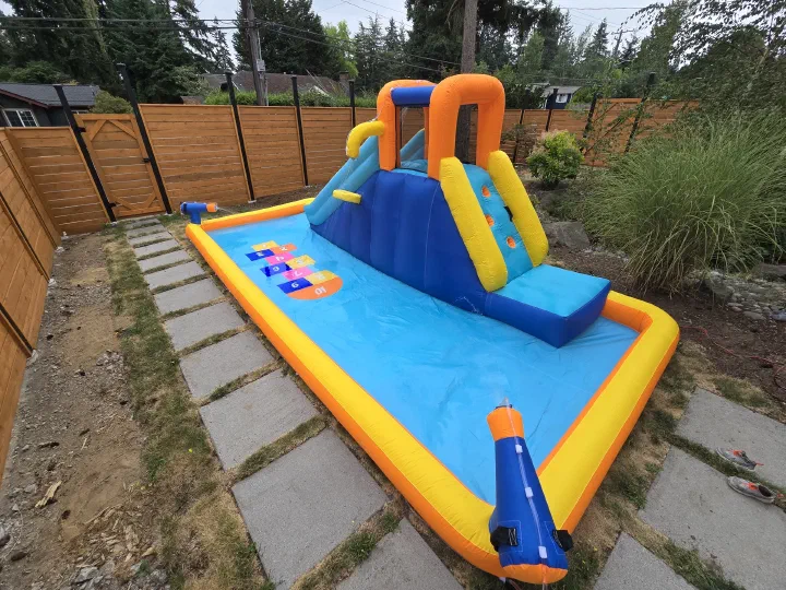 Completed inflatable water slide assembled in a backyard