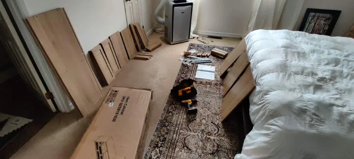 Flat-pack dresser parts laid out before assembly
