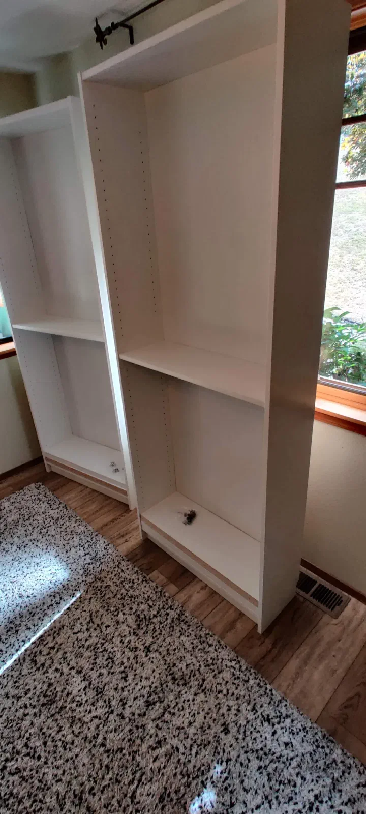 Two completed white freestanding shelving units