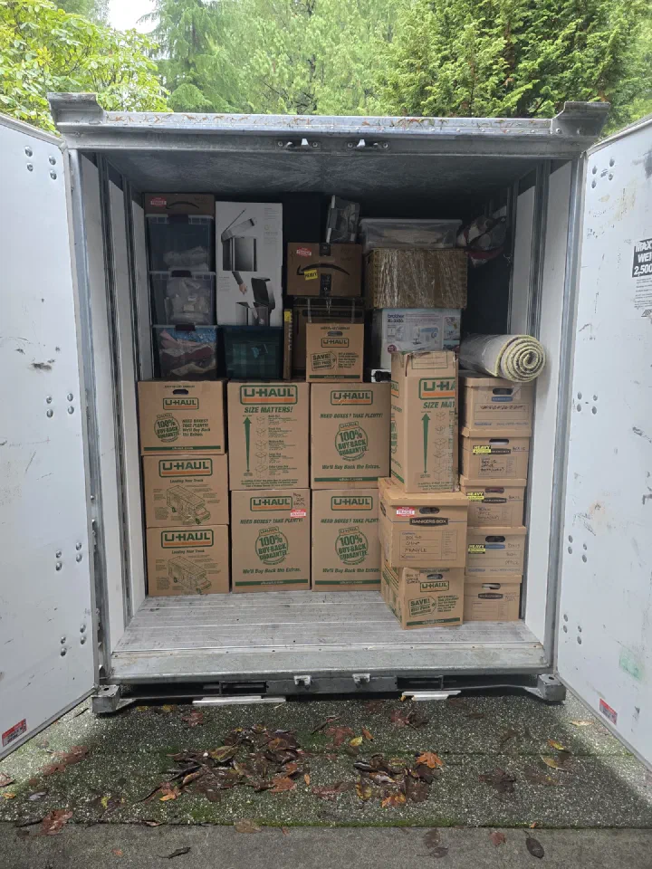 Portable storage pod carefully packed with moving boxes