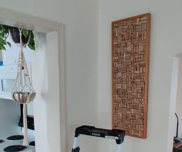 Carved wood wall panel mounted beside a doorway